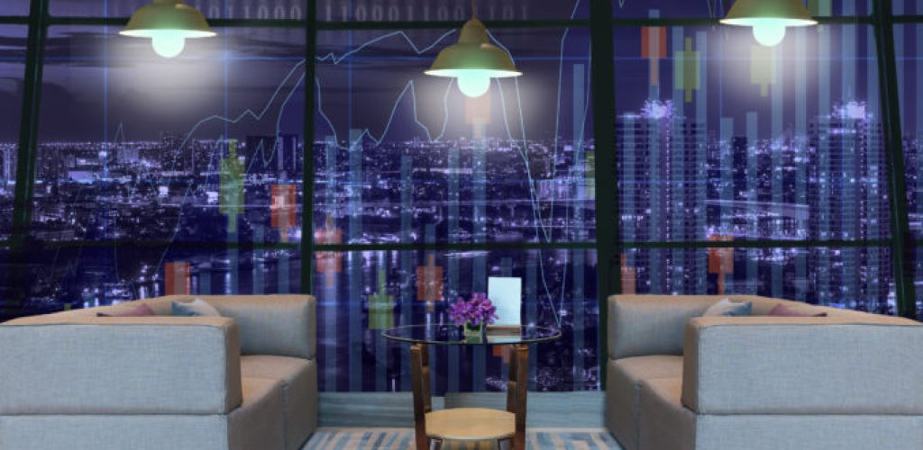 Lobby area of a hotel which can see Trading graph on the cityscape at night background with lighting,Business financial concept